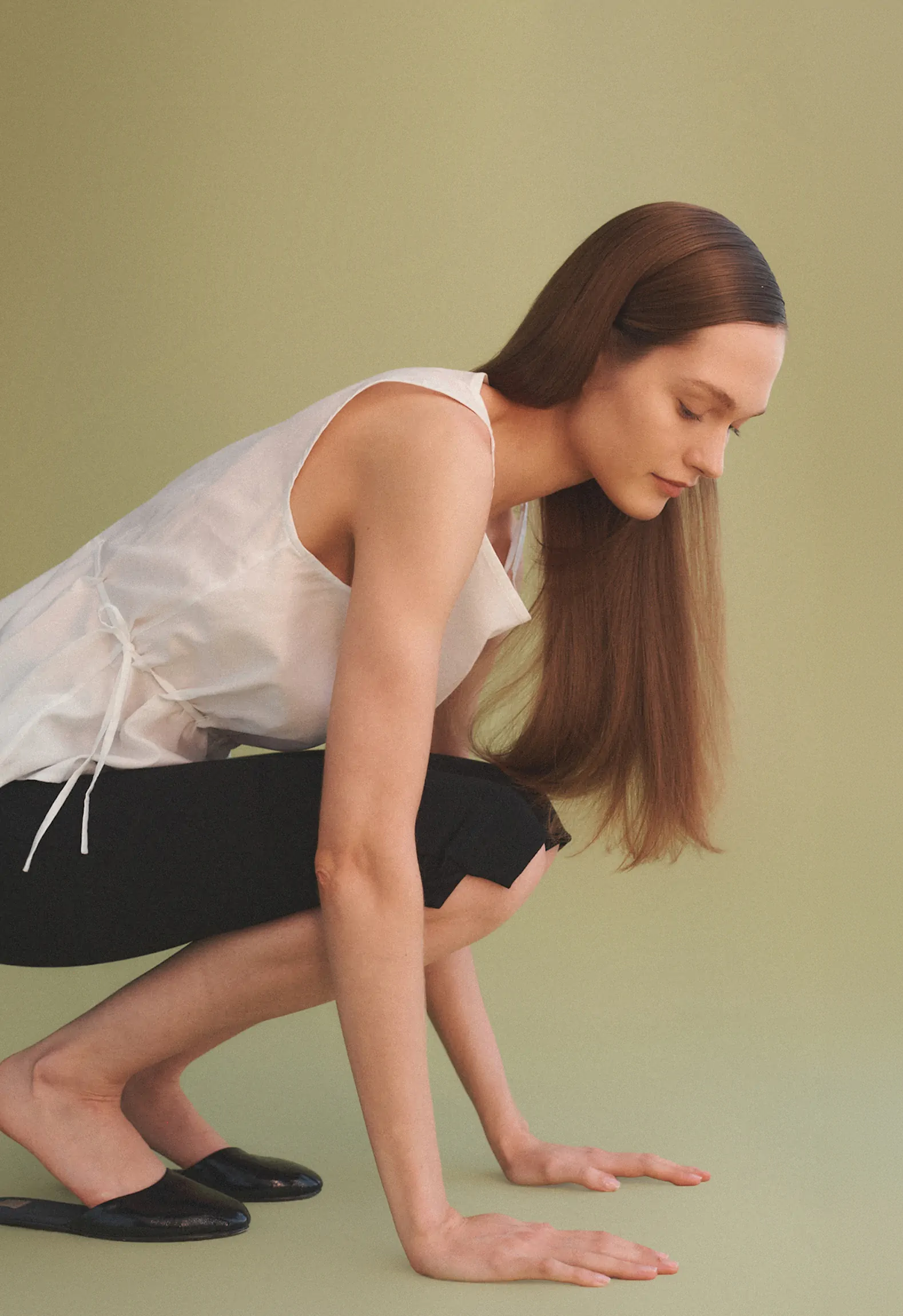 woman with hands on ground 