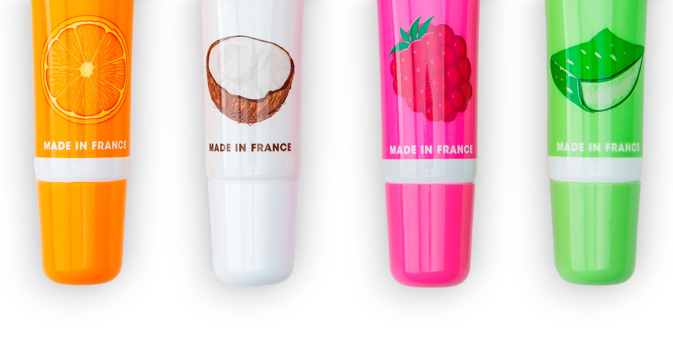 Four colorful lip balms with fruit illustrations: orange, coconut, strawberry, and lime.