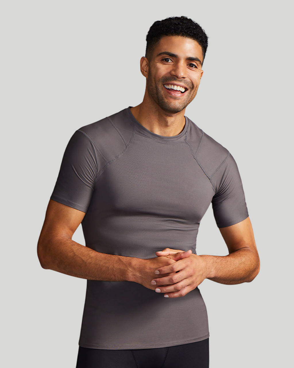 A man wearing a grey Tommie Copper Short Sleeve Shoulder Support Shirt