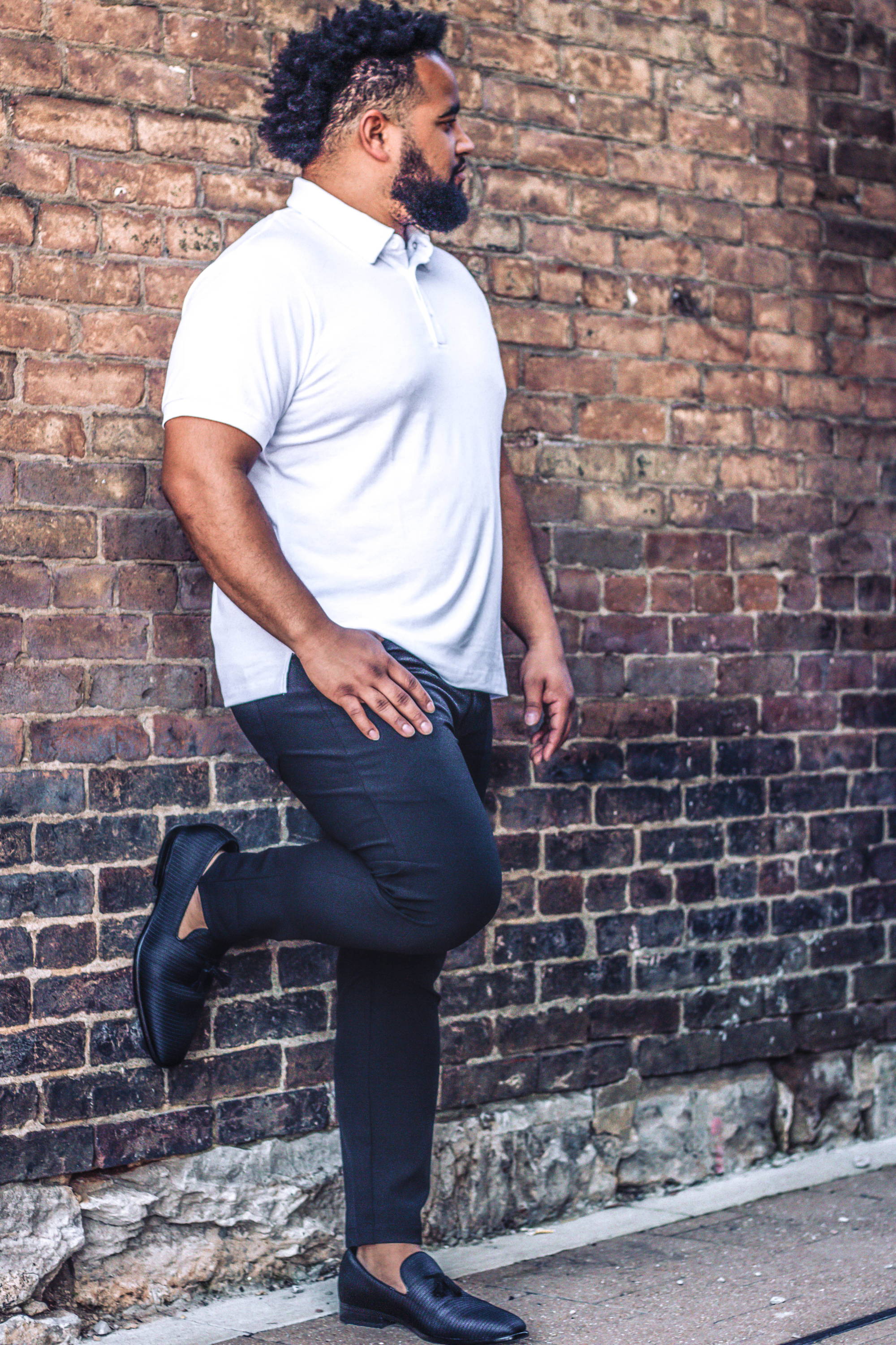 African American Male Wearing White Polo Shirt and Black Performance Pants from Under510.com