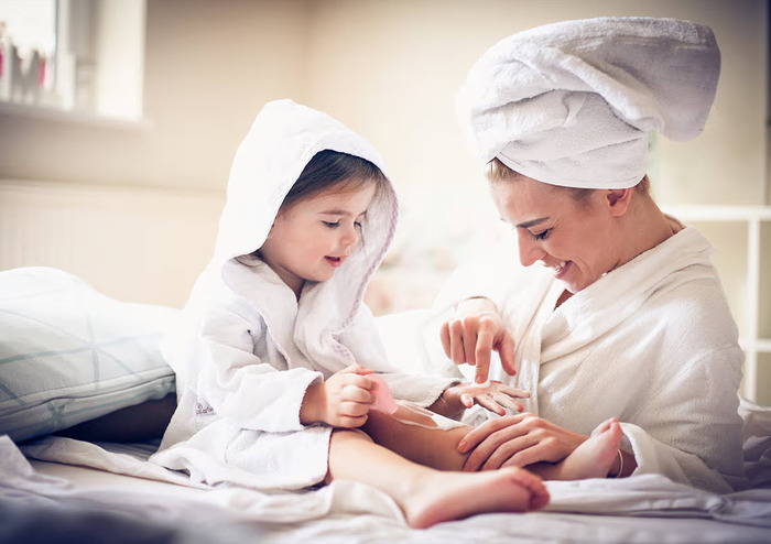 mother and child applying skin product
