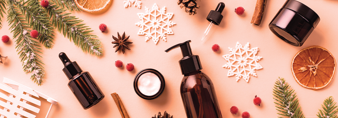 Aesthetic arrangement of skincare products with natural elements and festive decor.
