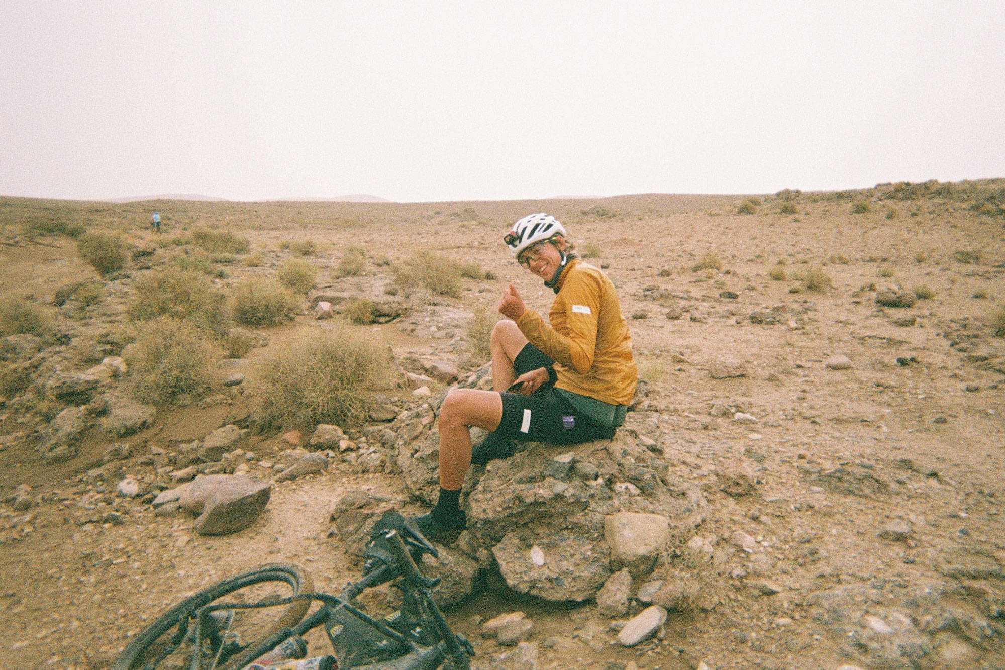 Marin sitting on a rock with his thumbs up to the camera