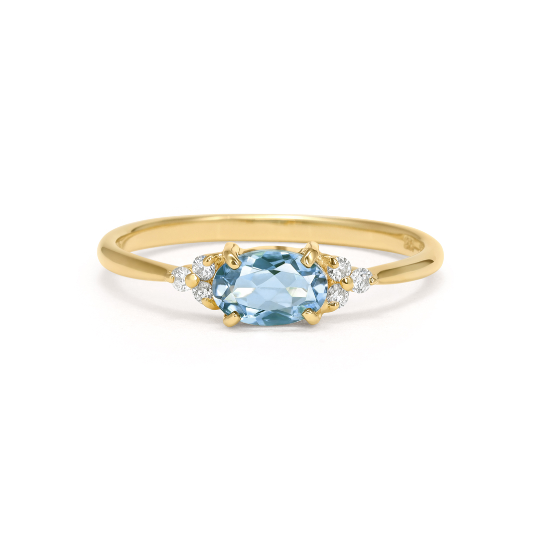 Gold ring with a blue gemstone and small diamonds.