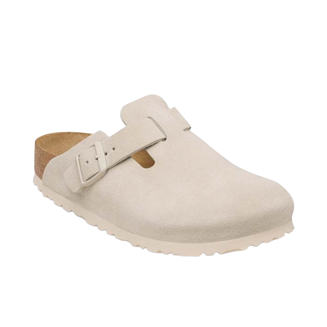 A white slip-on shoe with a buckle strap.