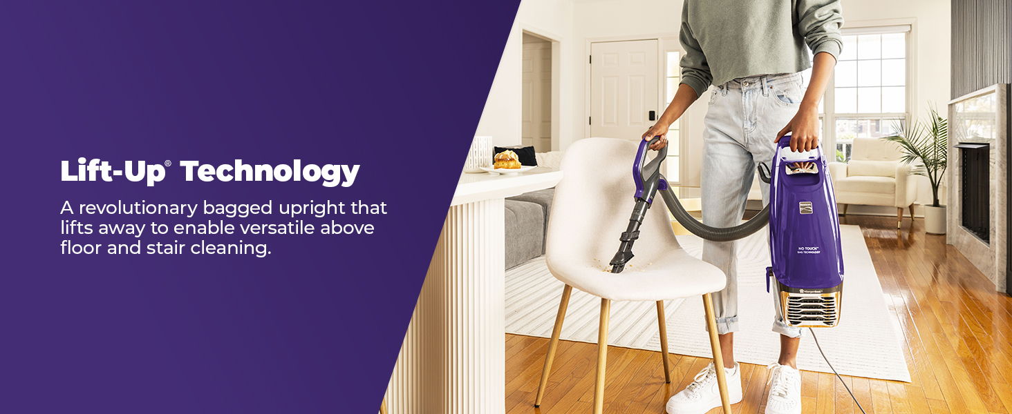 Person using a vacuum cleaner with lift-up technology in a bright room.