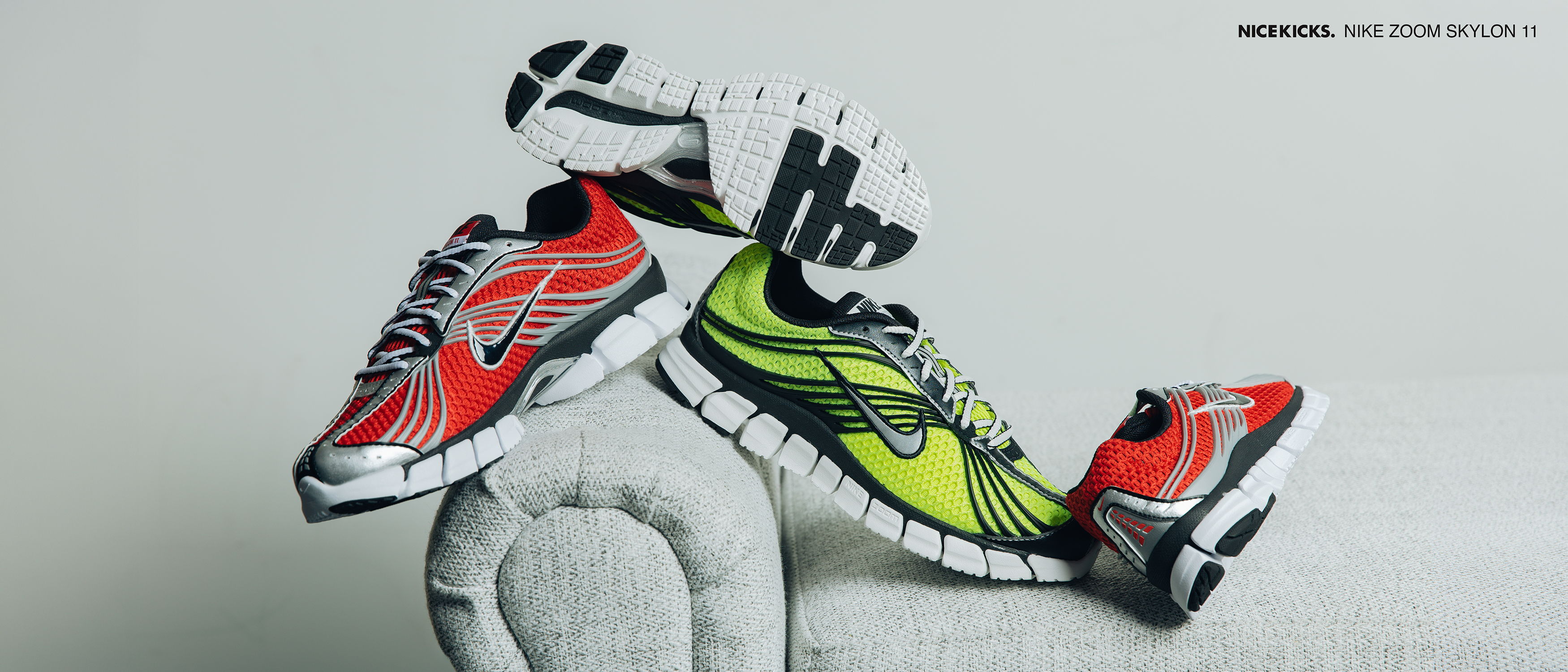 Three pairs of colorful athletic shoes arranged creatively on a surface.