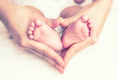 A picture of a mother holding a baby's feet