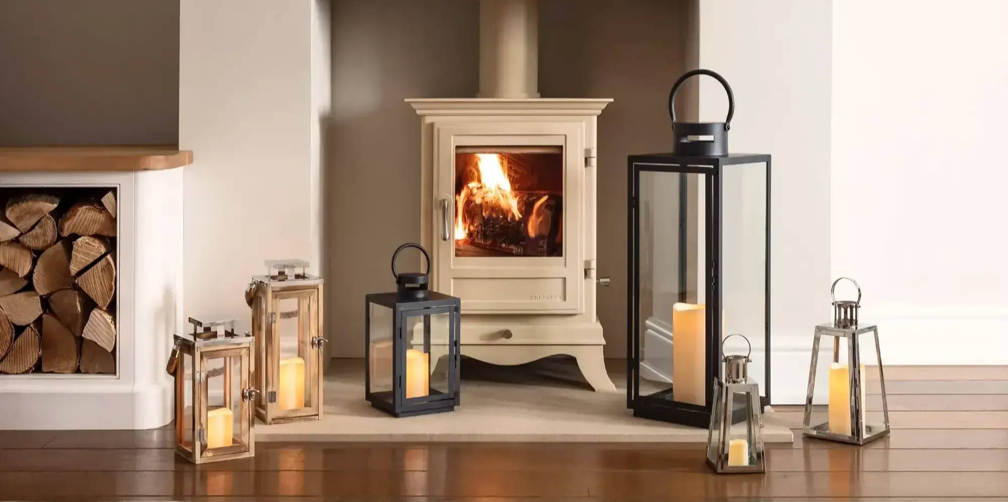 indoor lanterns and candles in front of a fireplace