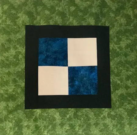 Quilt Top showing 4 block center patch, Border 1 and Border 2