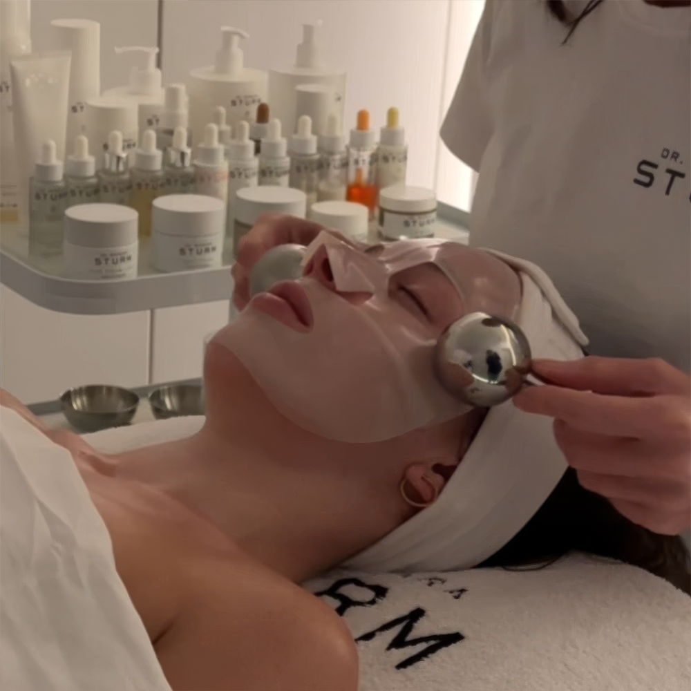 Person receiving a facial treatment with a professional applying tools.