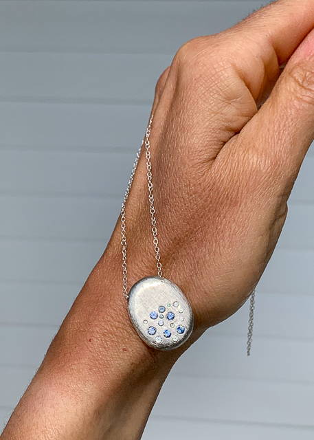 starburst silver necklace with white and blue sapphires