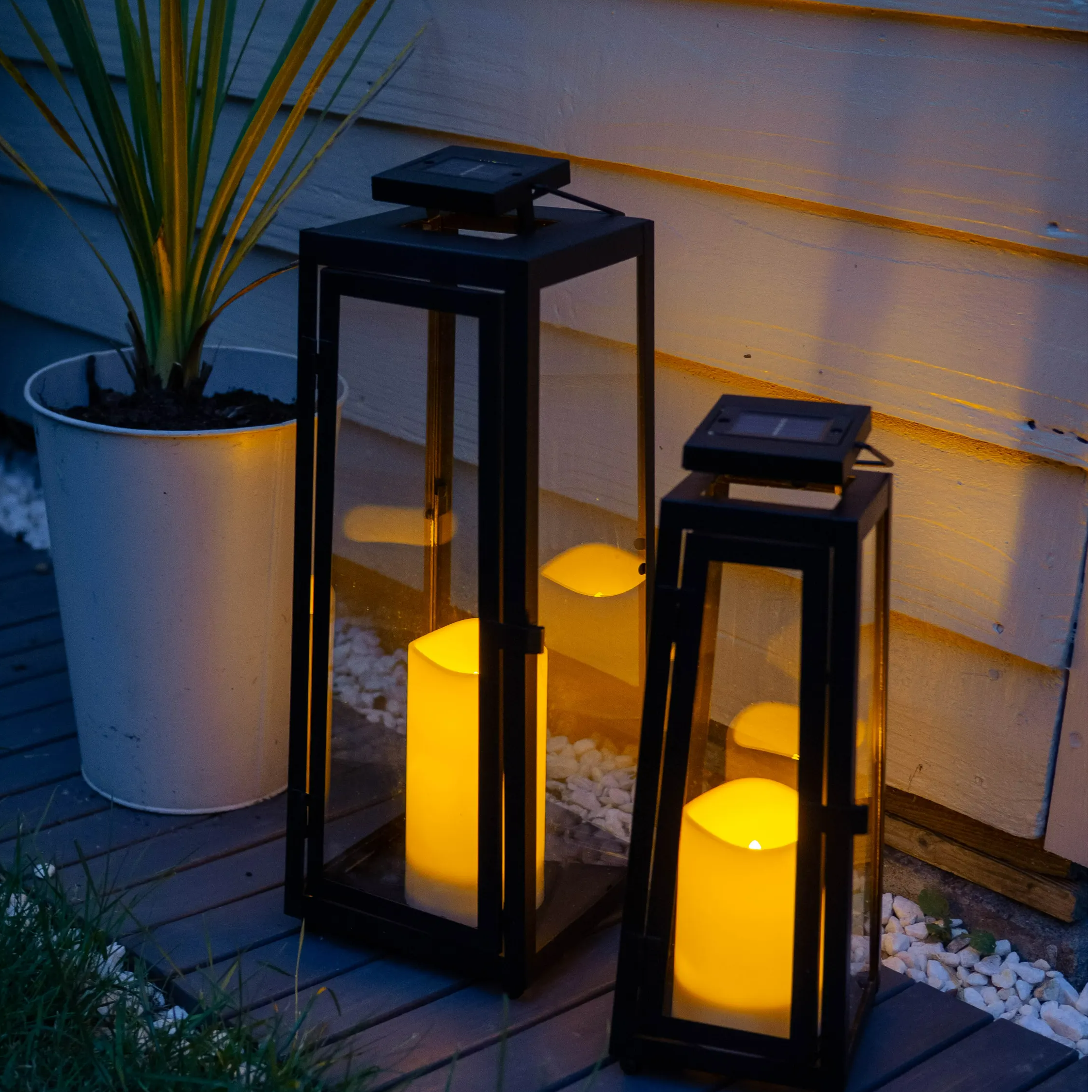 Close up of garden solar lanterns at night lit up.