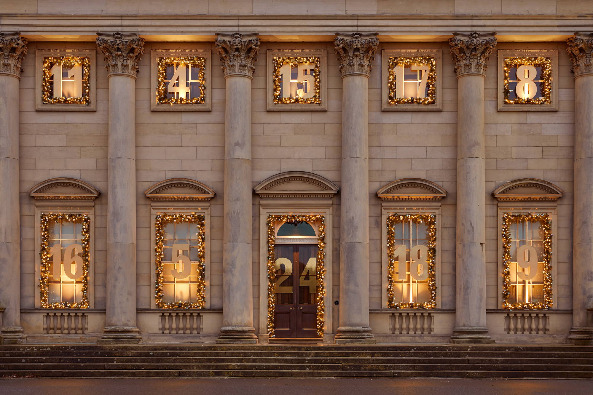 A festive advent calendar created with Christmas Garlands dressing the front of Harewood House Stately Home