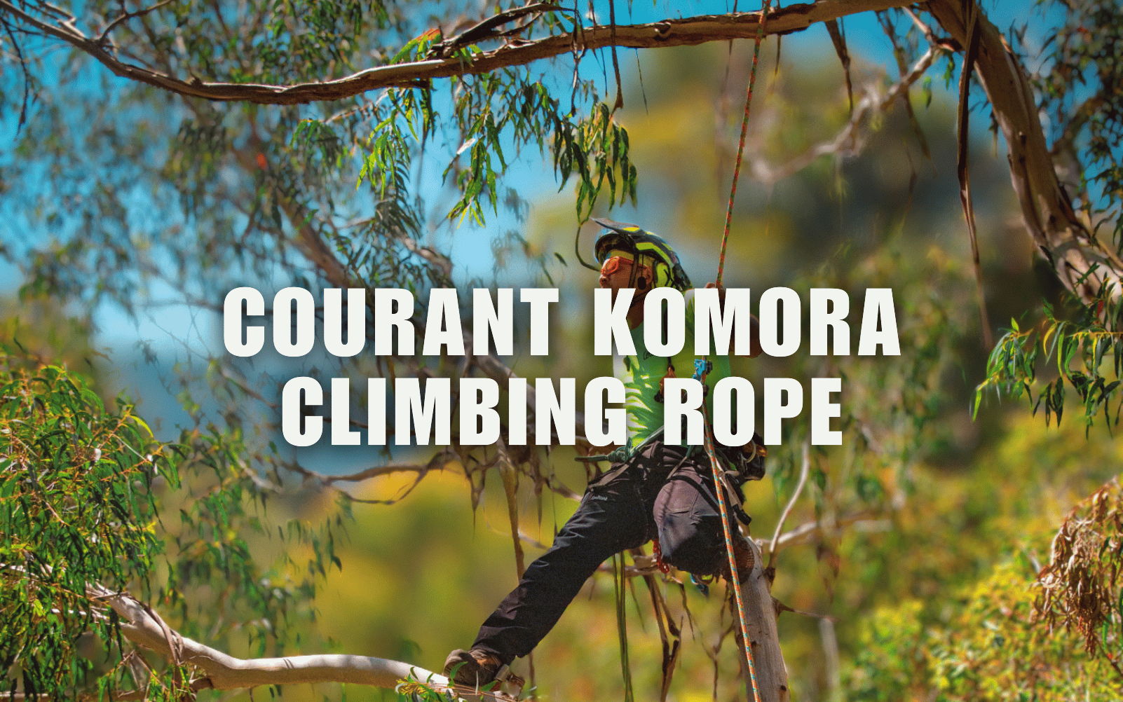 A person climbing with a Courant Komora climbing rope in nature.