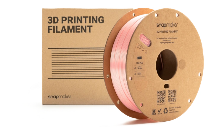 3D printing filament spool next to its packaging.