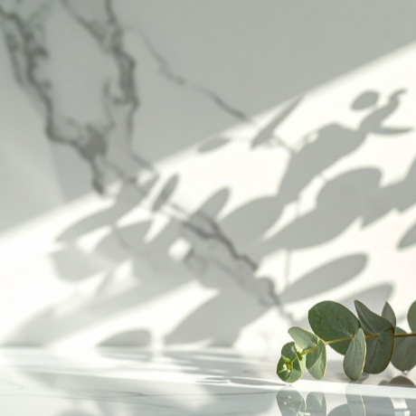 Three amber dropper bottles with shadows and greenery on a light background.