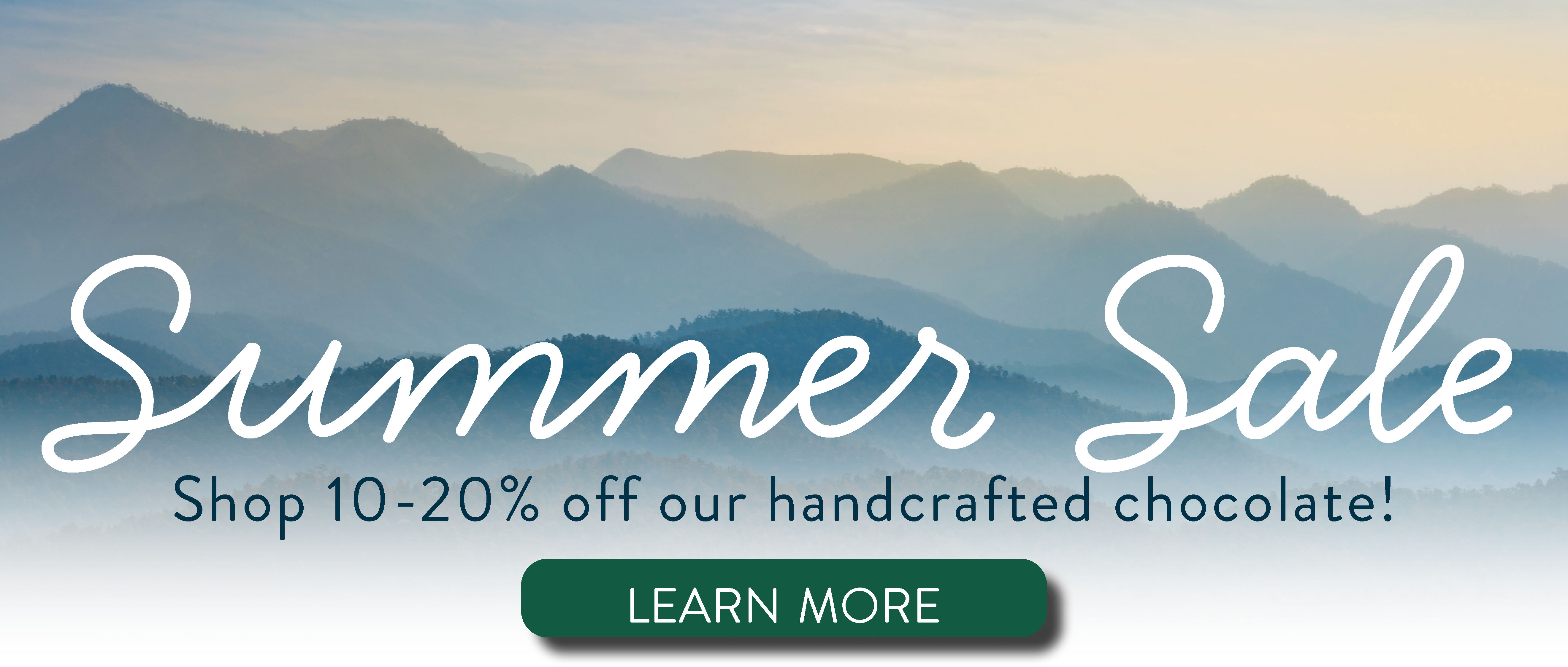 Text promoting a summer sale on chocolate products with mountains in the background.
