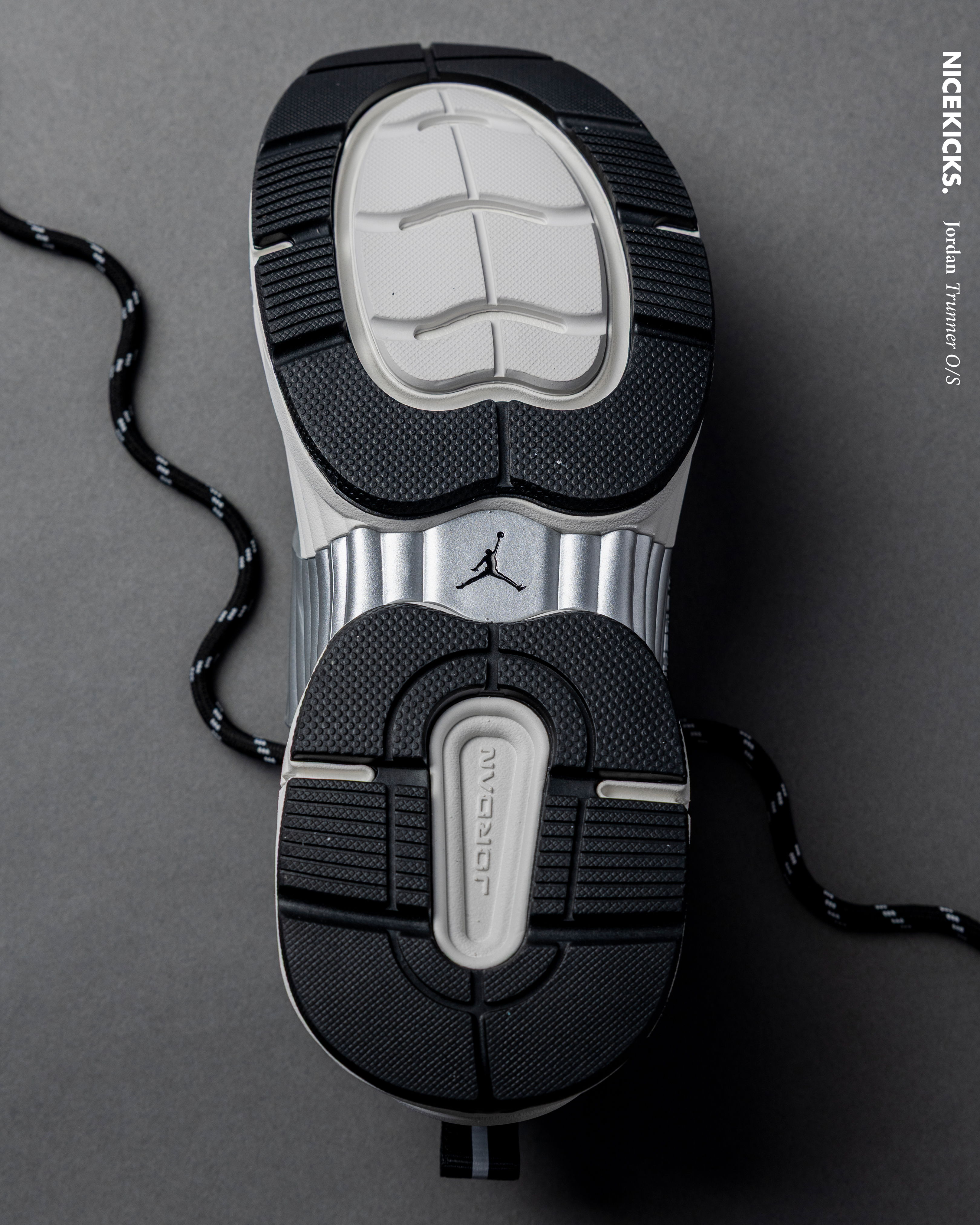 Bottom view of a sneaker sole with a black and gray design.