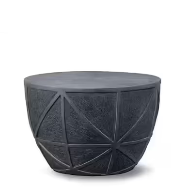 A round, textured black table with geometric patterns.