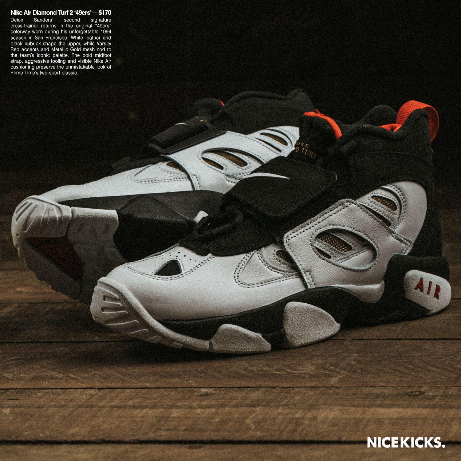 White and black sneakers with red accents on a wooden surface.
