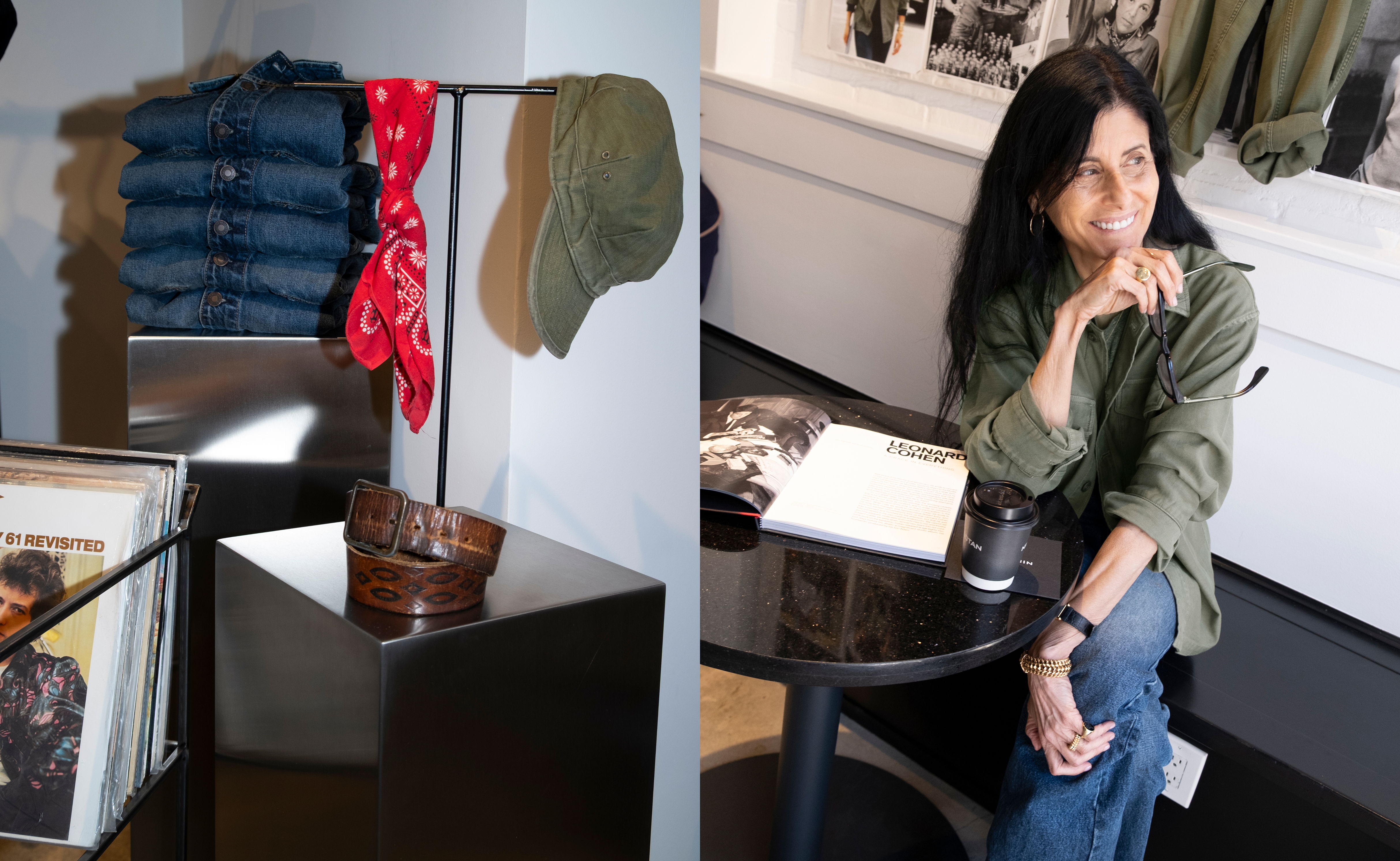 A woman sitting at a table with clothing and accessories displayed nearby.