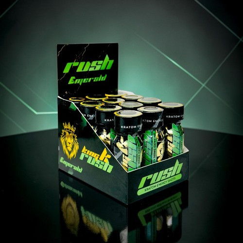 Display of energy drink cans in a branded box against a dark background.