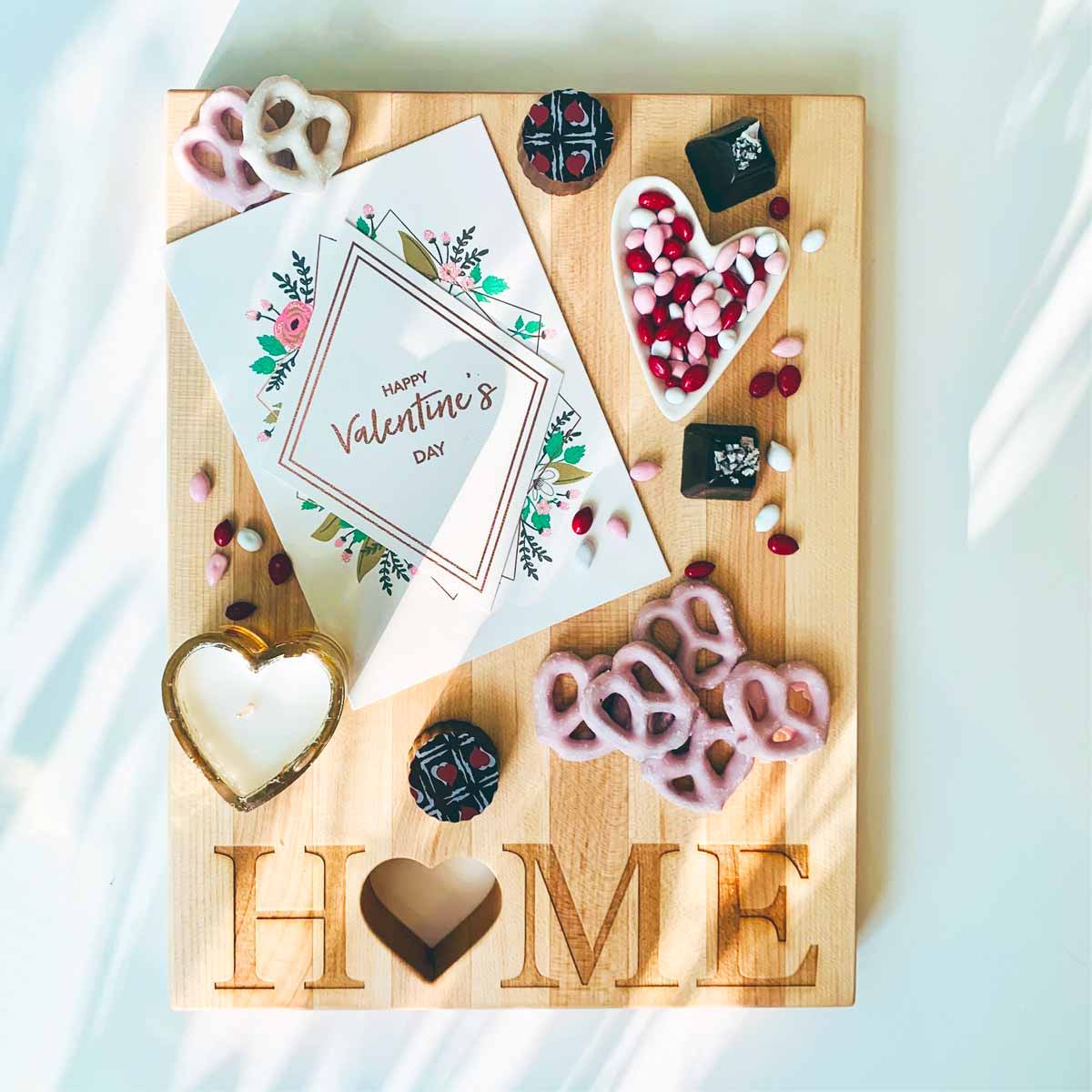 Wooden Cutting Board with the word Home with a heart shaped O written at the bottom