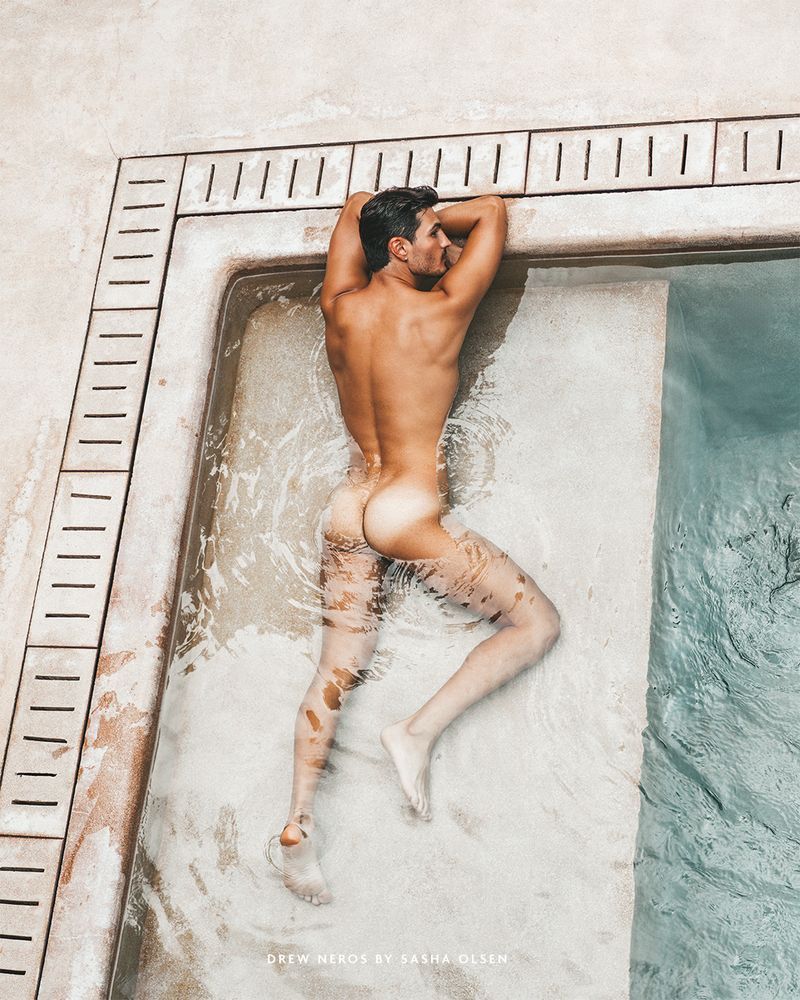 A person relaxing by the edge of a pool.