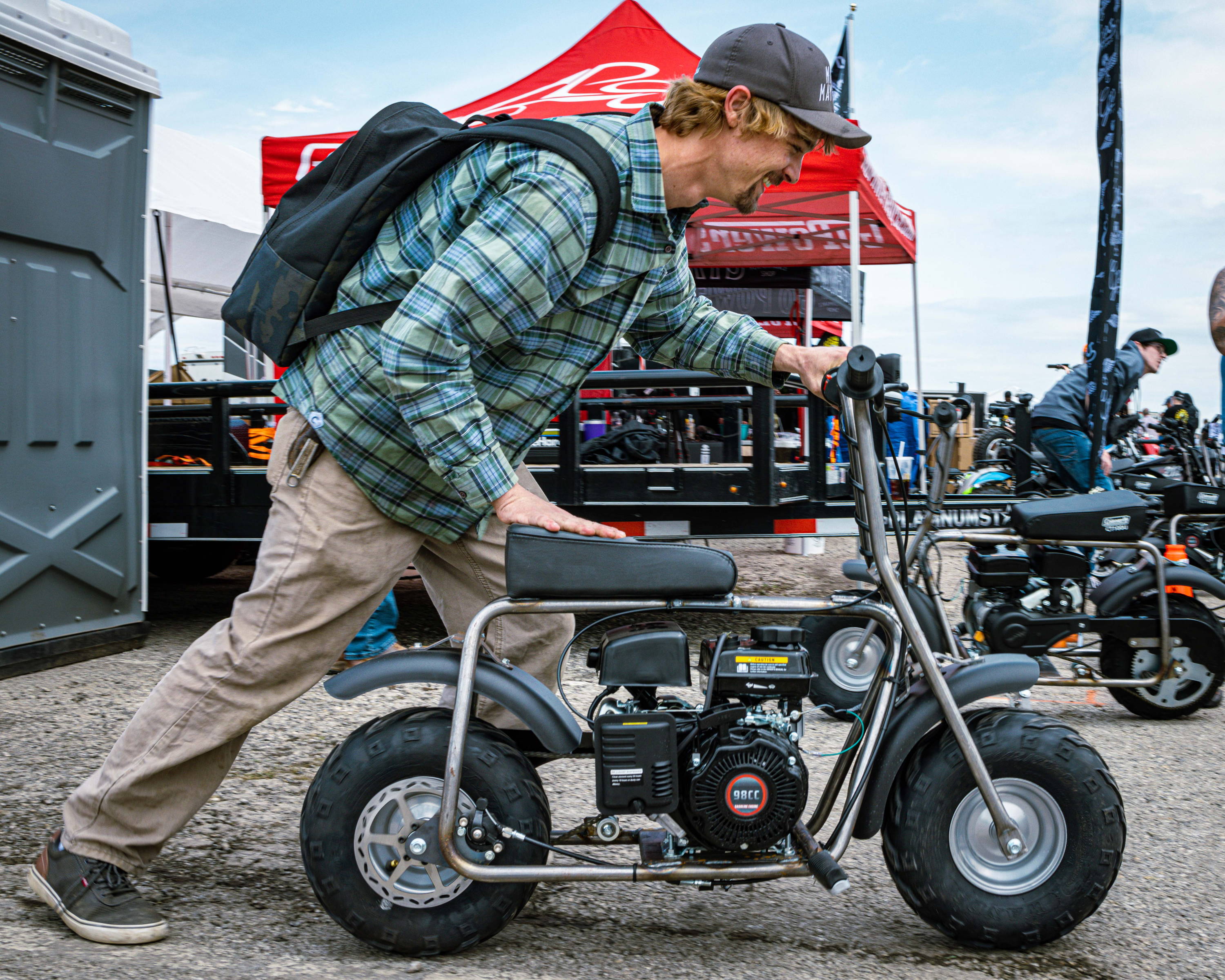 Charles from Cars and Cameras pushing a Maverick 98 Minibike Kit at the Pate Swap Meet