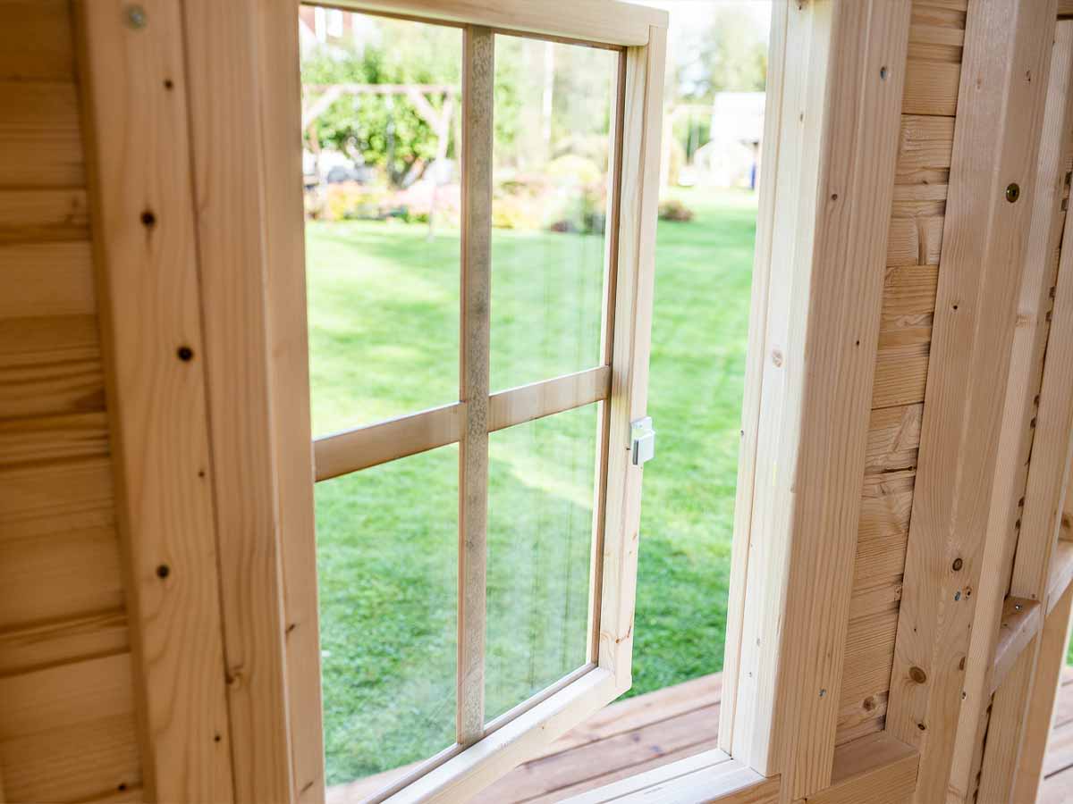 Close-up of functional safety glass window of Easy Setup Kids Playhouse Natural Wonder by WholeWoodPlayhouses