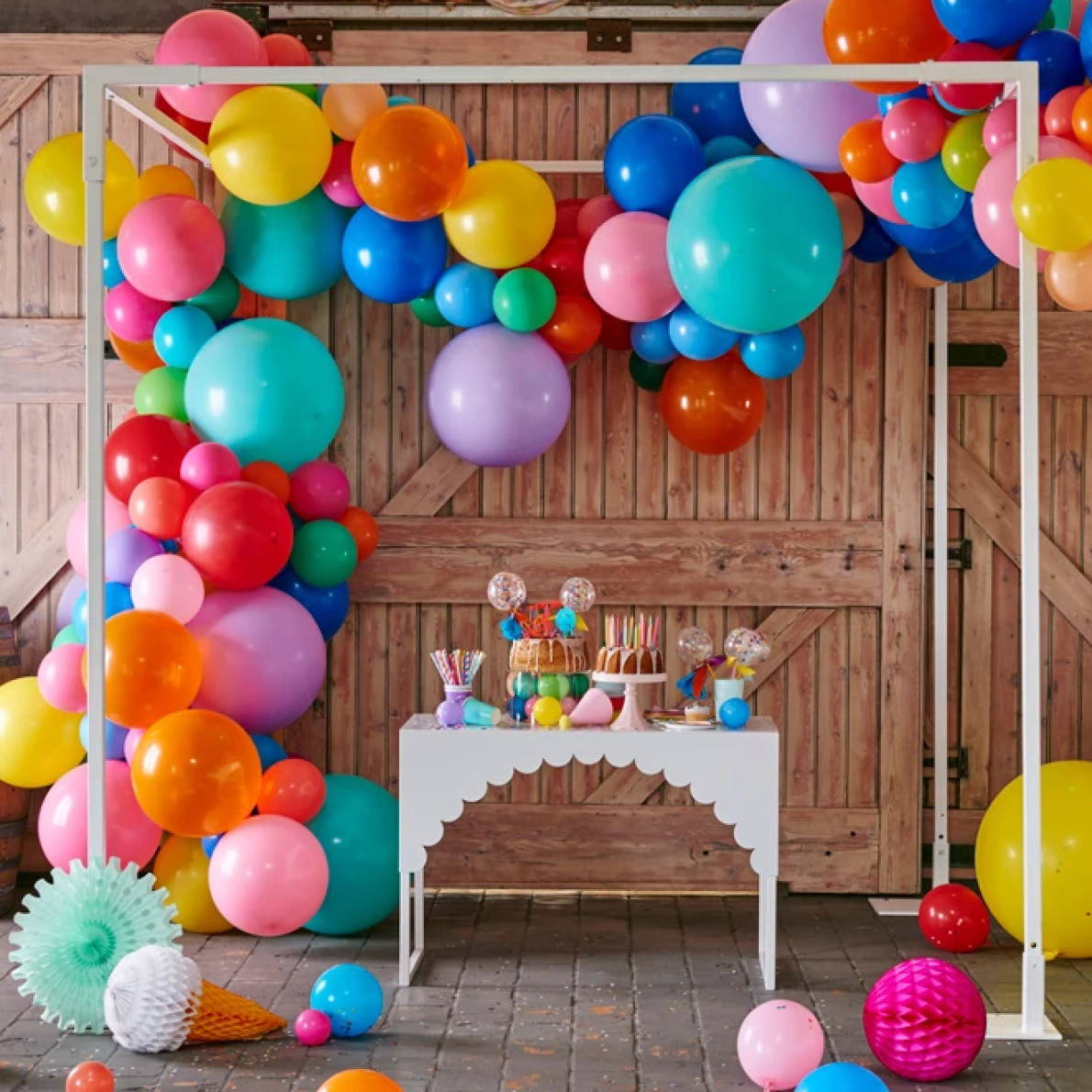 Image of balloon display around small party table.