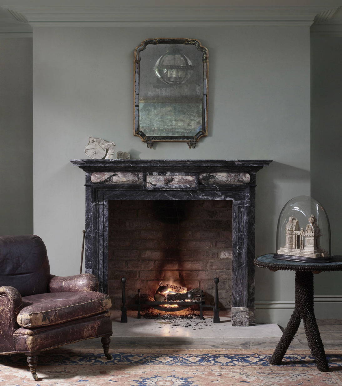 a grand marble fireplace in an english country styled home