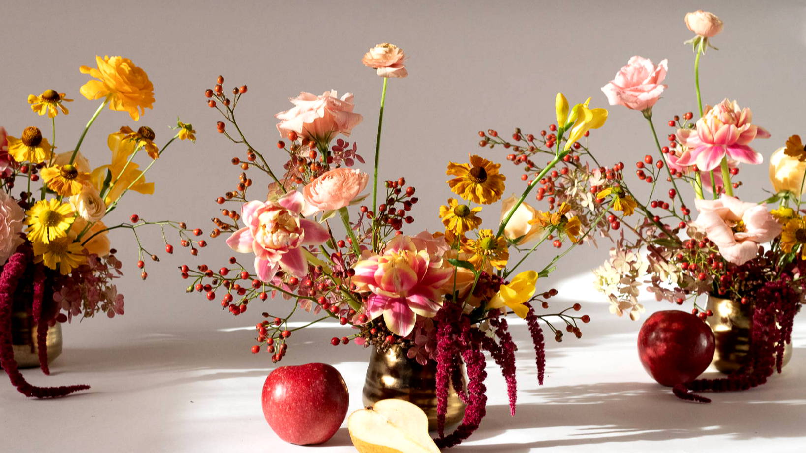 Three gold mini tegan floral arrangements
