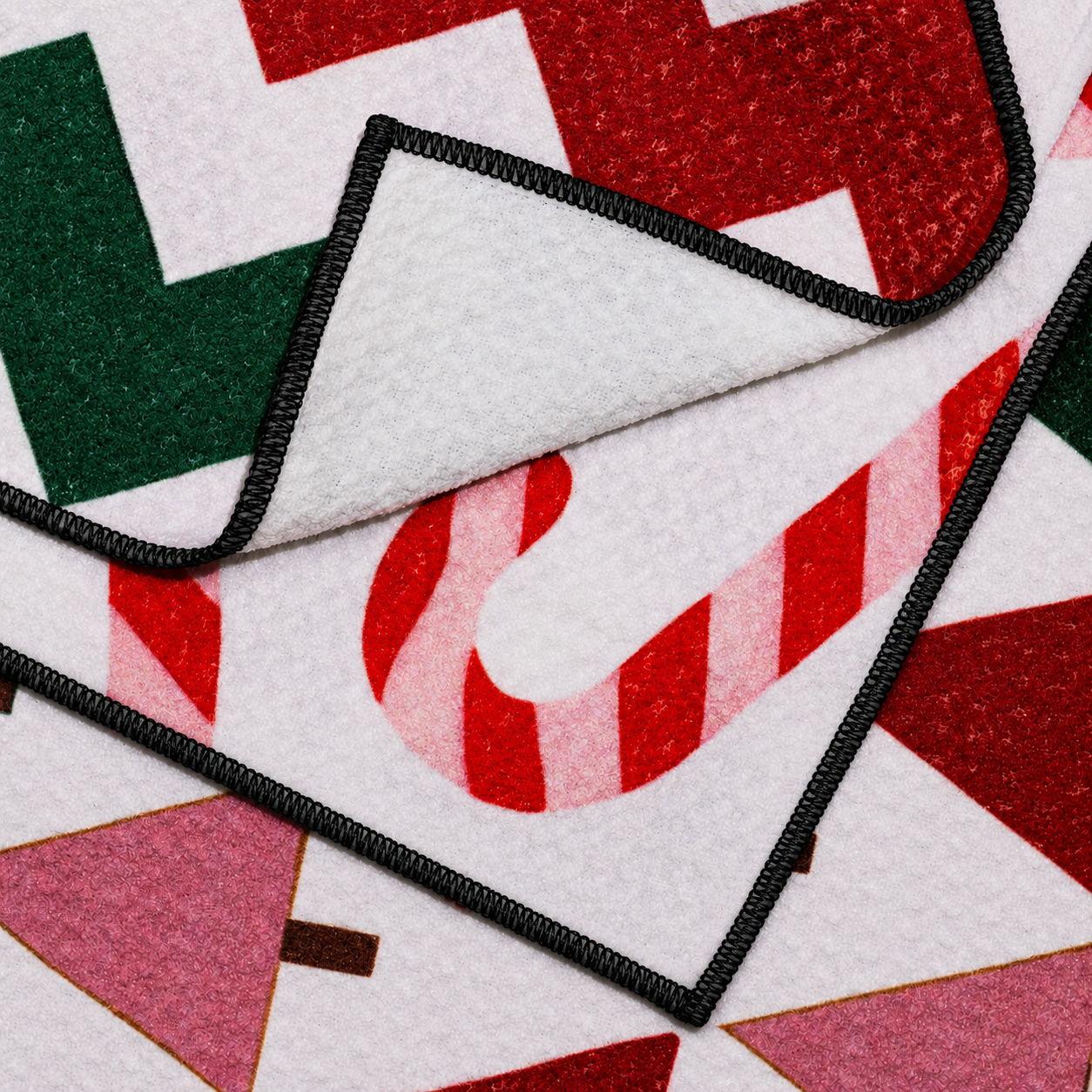 Decorative holiday-themed rug with candy cane and geometric patterns.
