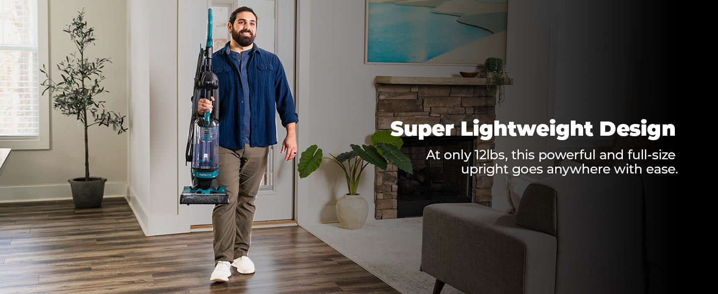 Man using a lightweight vacuum cleaner in a modern living space.