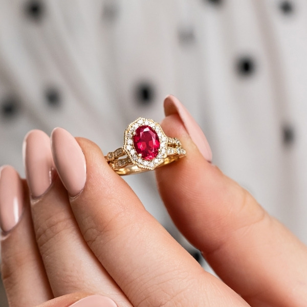 vintage style diamond halo accented ruby engagement ring in yellow gold