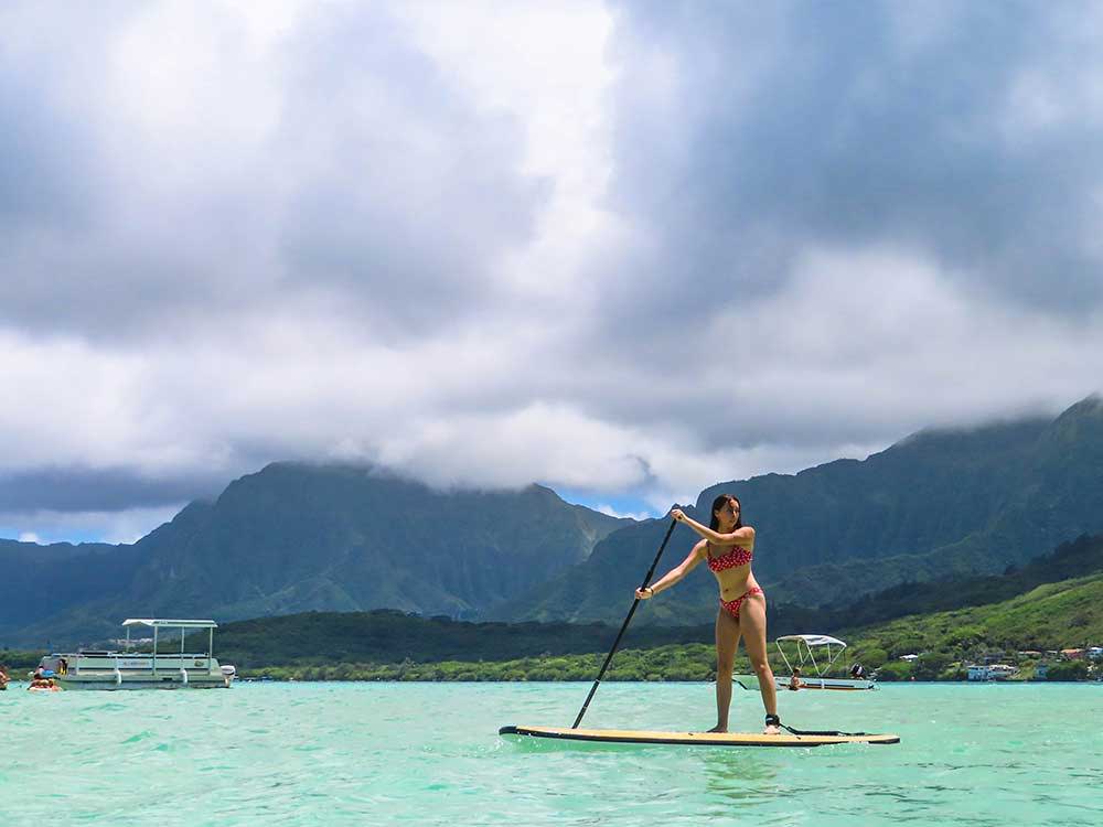 girl paddling on an all around stand up paddle board