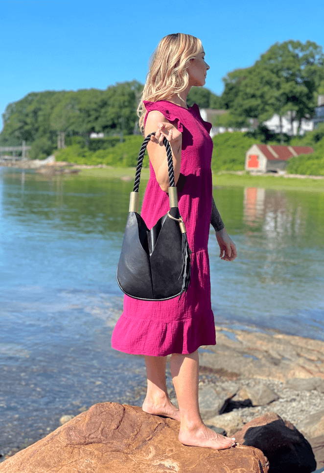 woman holding bag on the beach