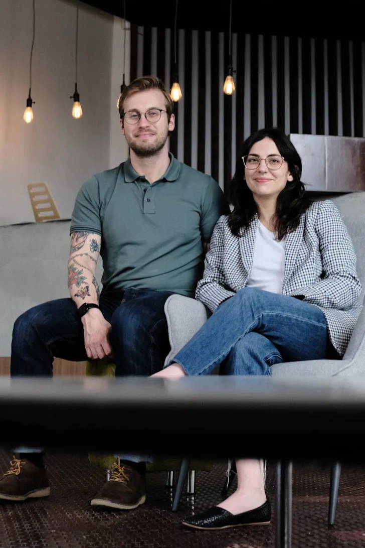 Photo of Future Fields' co-founders Matt Anderson-Baron and Jalene Anderson-Baron sitting in Edmonton Headquarters office