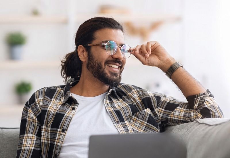 Man wearing Joy Silver eyeglasses with anti-reflective coating