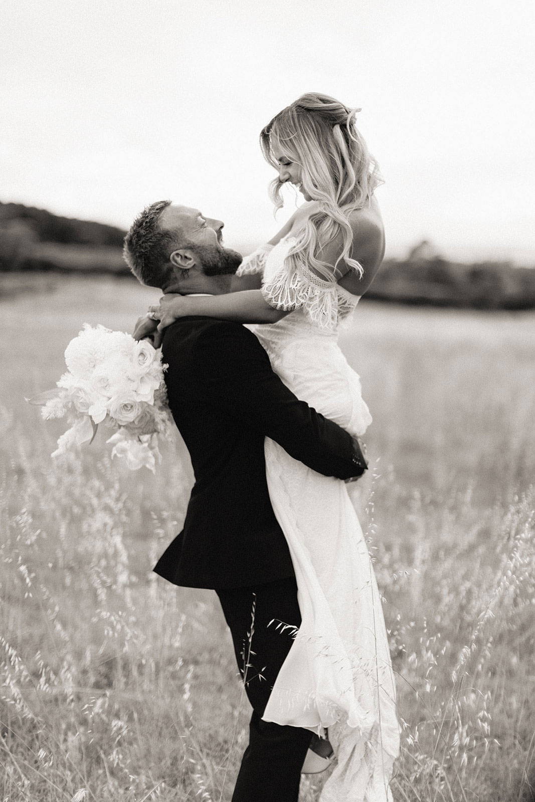 Groom lifting up his bride