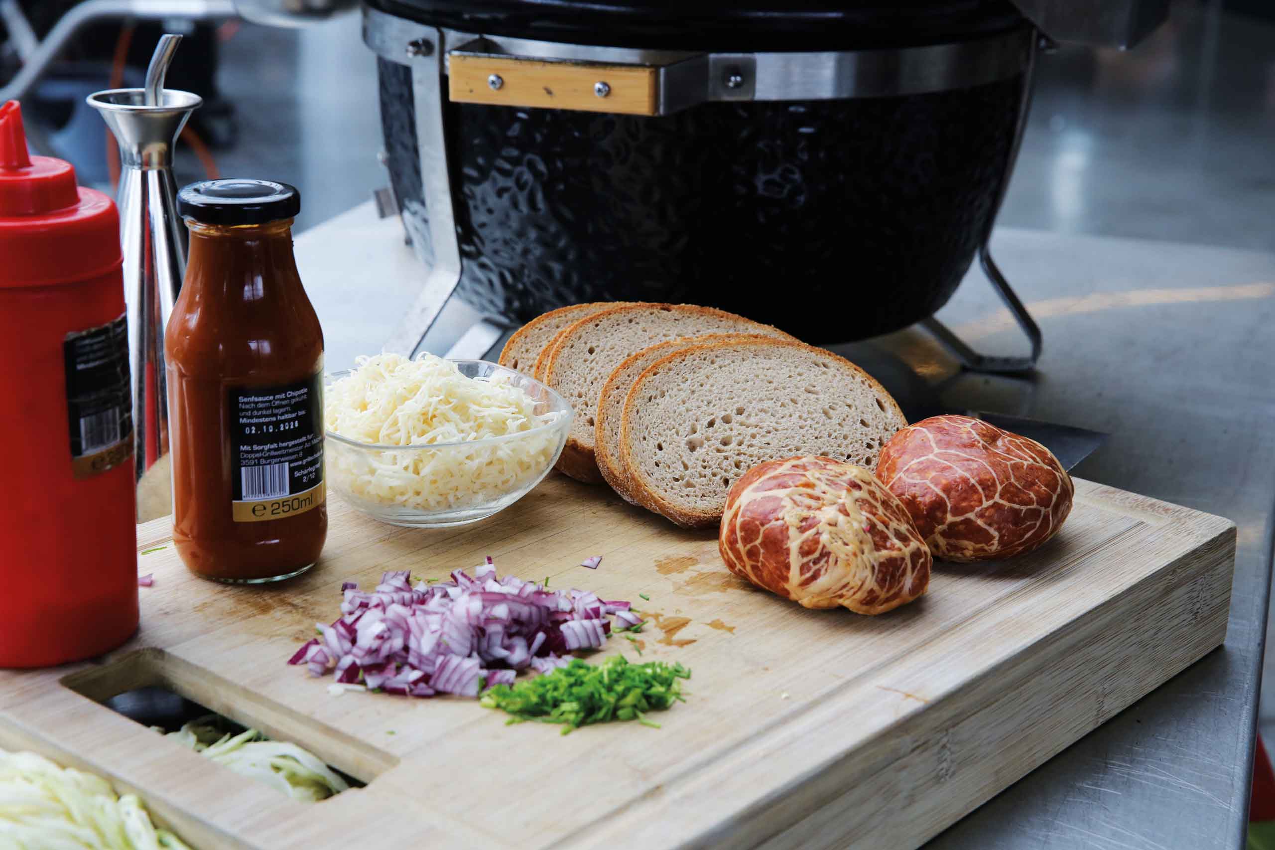 Ingredients for a meal: bread, sauce, cheese, onions, and herbs on a cutting board.