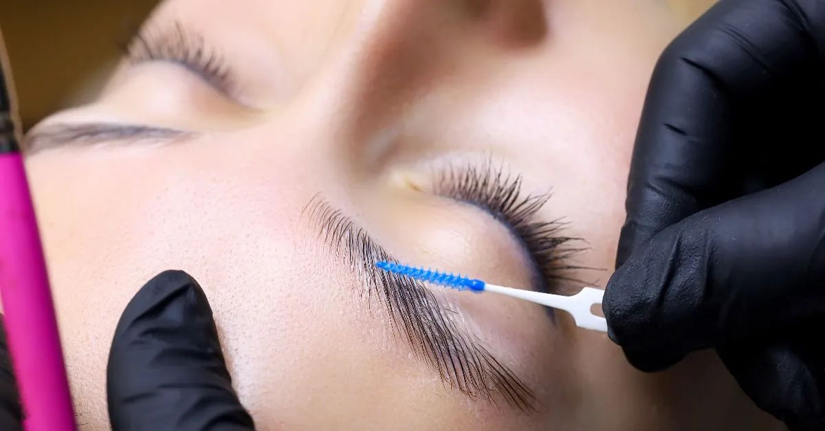 A female client having a brow treatment in a salon.