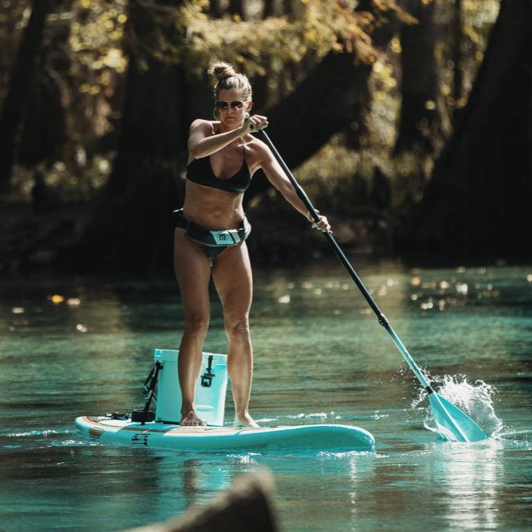 Woman paddling on her Breeze 10′6″ Classic Teak Paddle Board