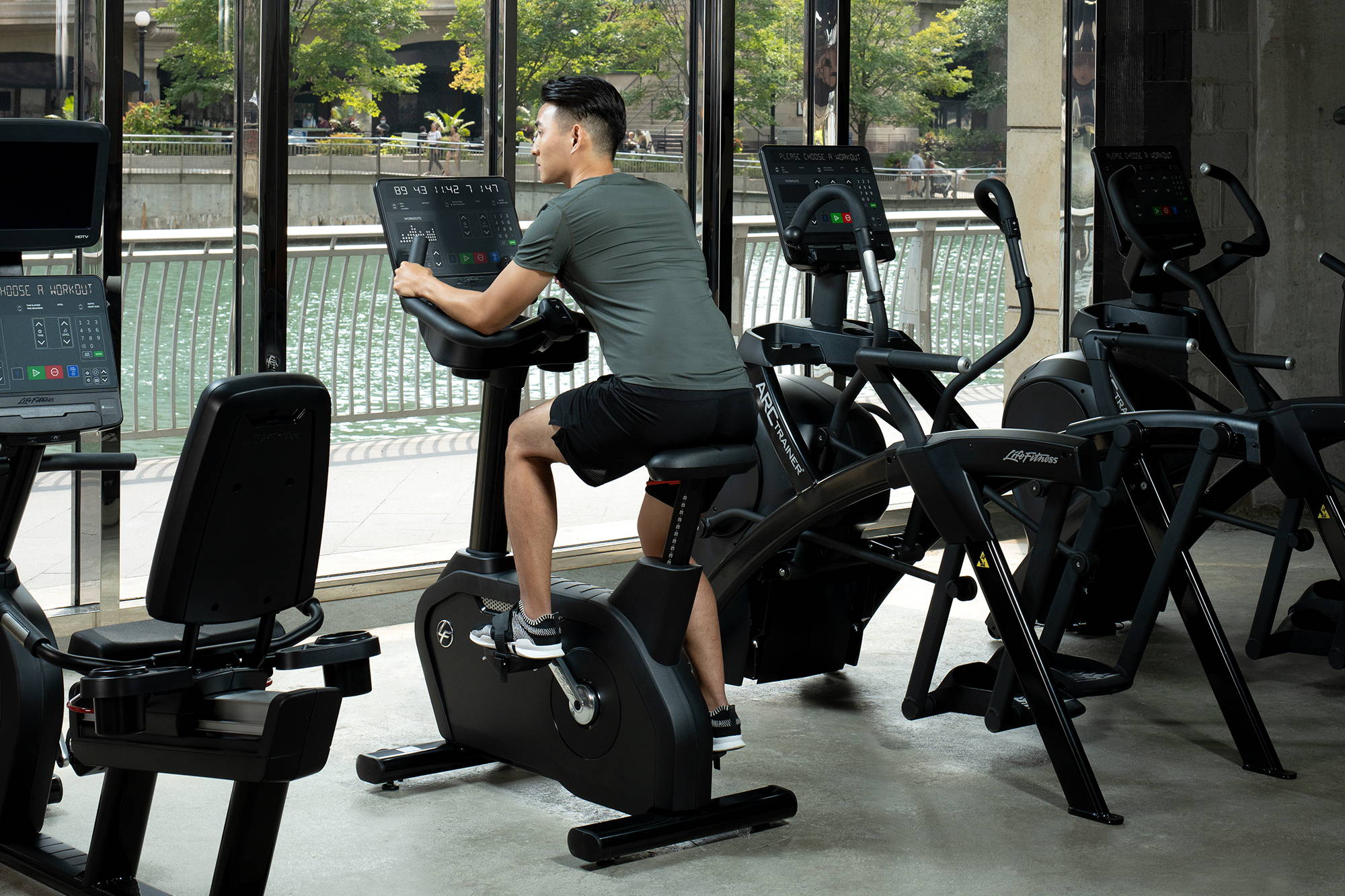 Man exercising on Club Series+ Upright Bike in Gym