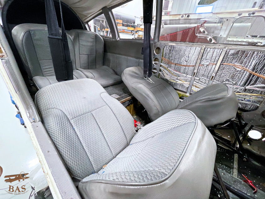 Interior of an aircraft showing gray leather seats.
