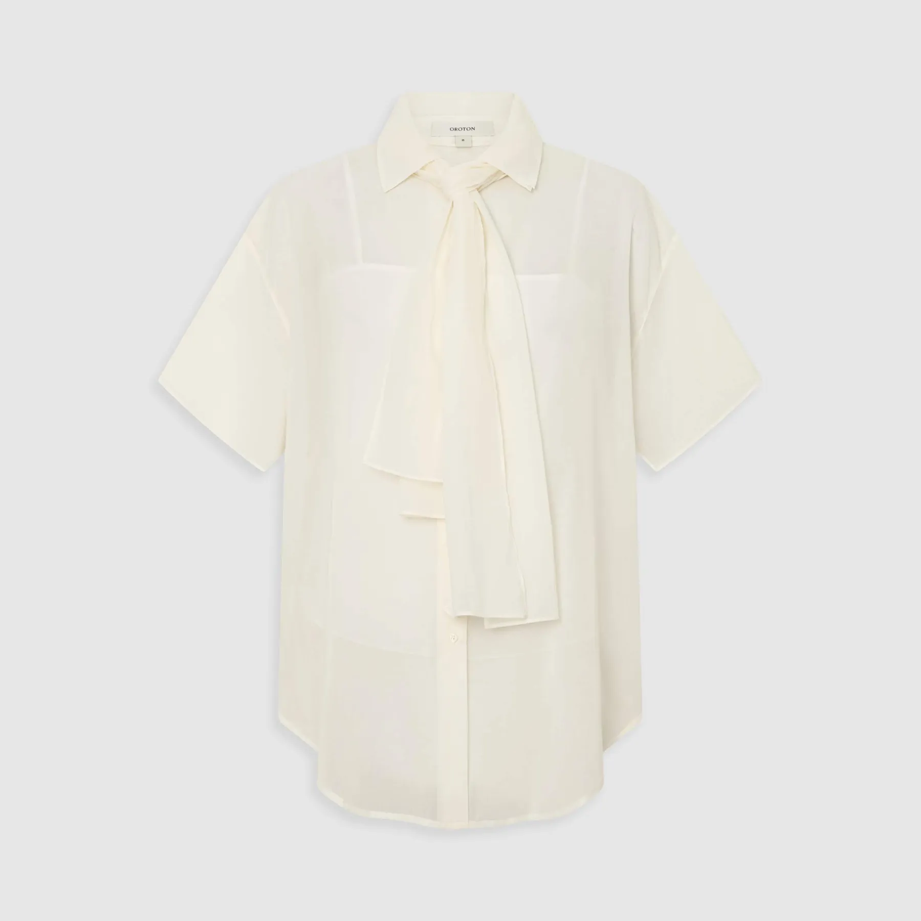 White blouse with short sleeves and a tie detail at the neck.