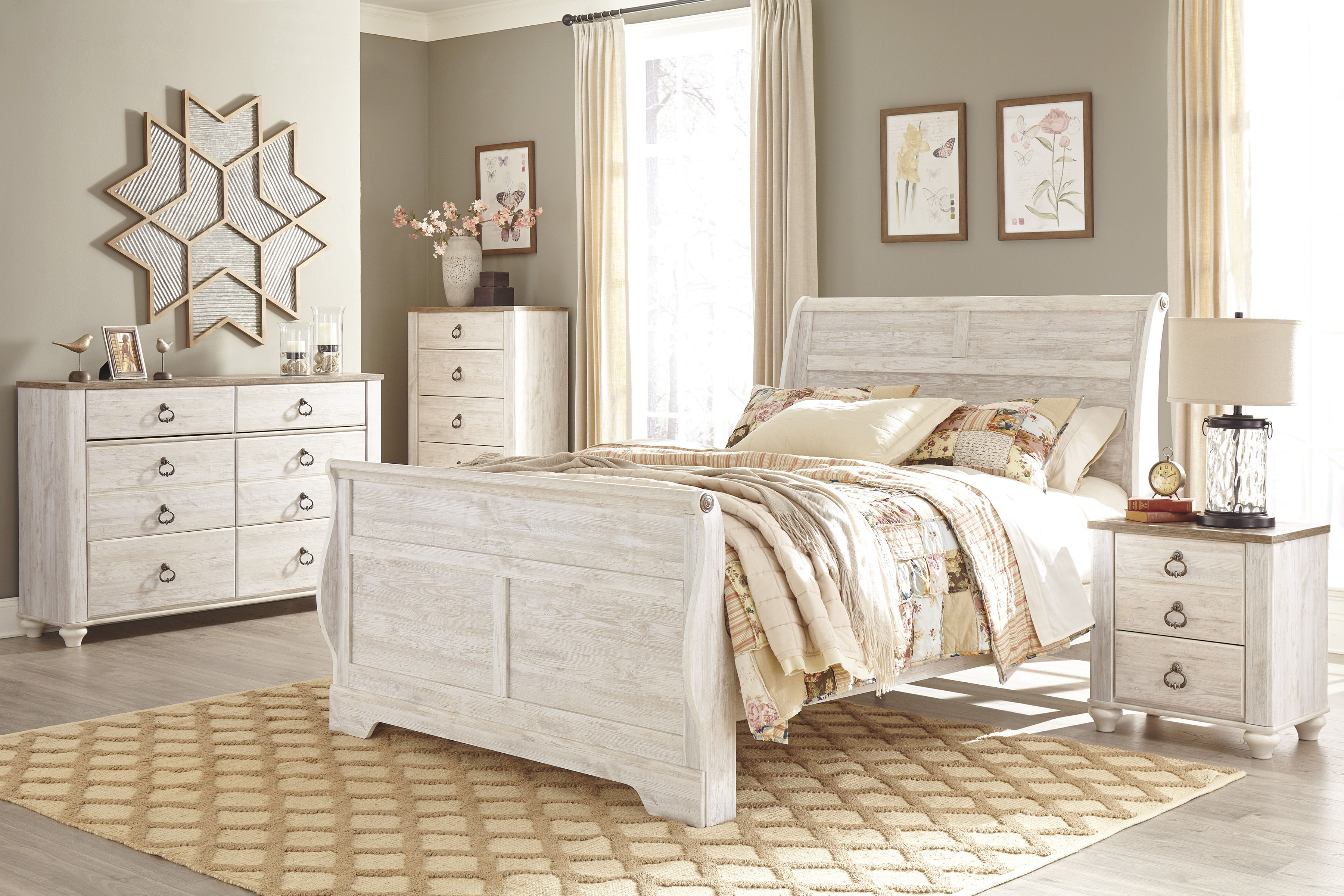 Cozy bedroom with white furniture, warm tones, and decorative wall art.