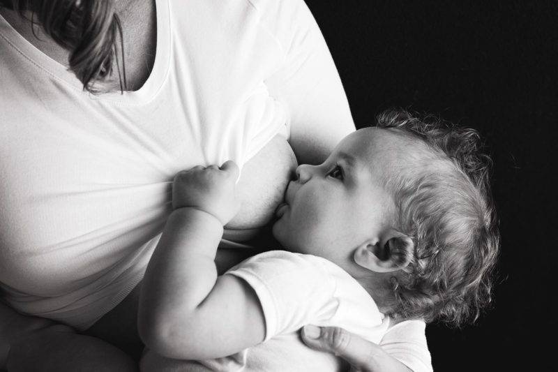A Woman Breastfeeding Her Child